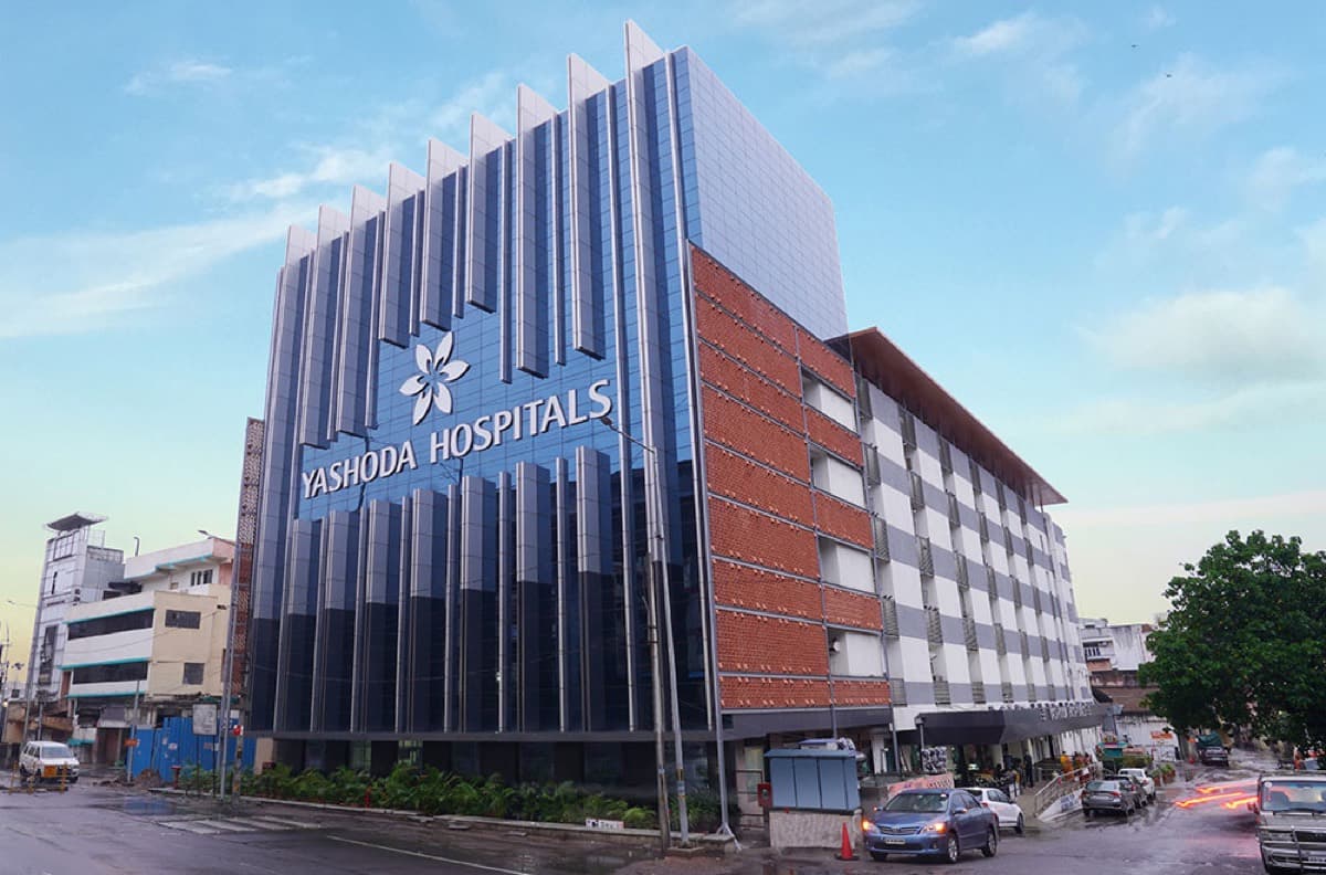 The angular blue and terracotta facade of Yashoda Hospitals at Malakpet, Hyderabad.