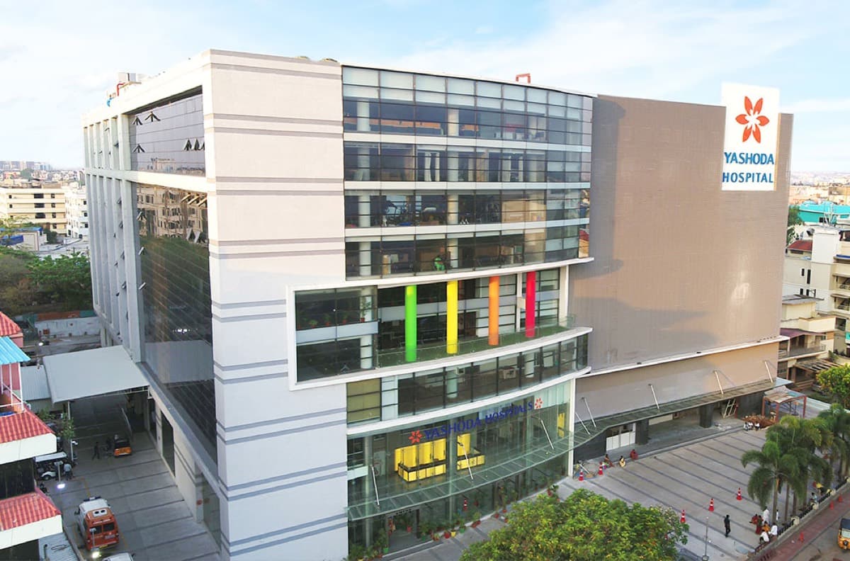 The white and glass frontage of Yashoda Hospital in Secunderabad, with coloured panels along one elevation.