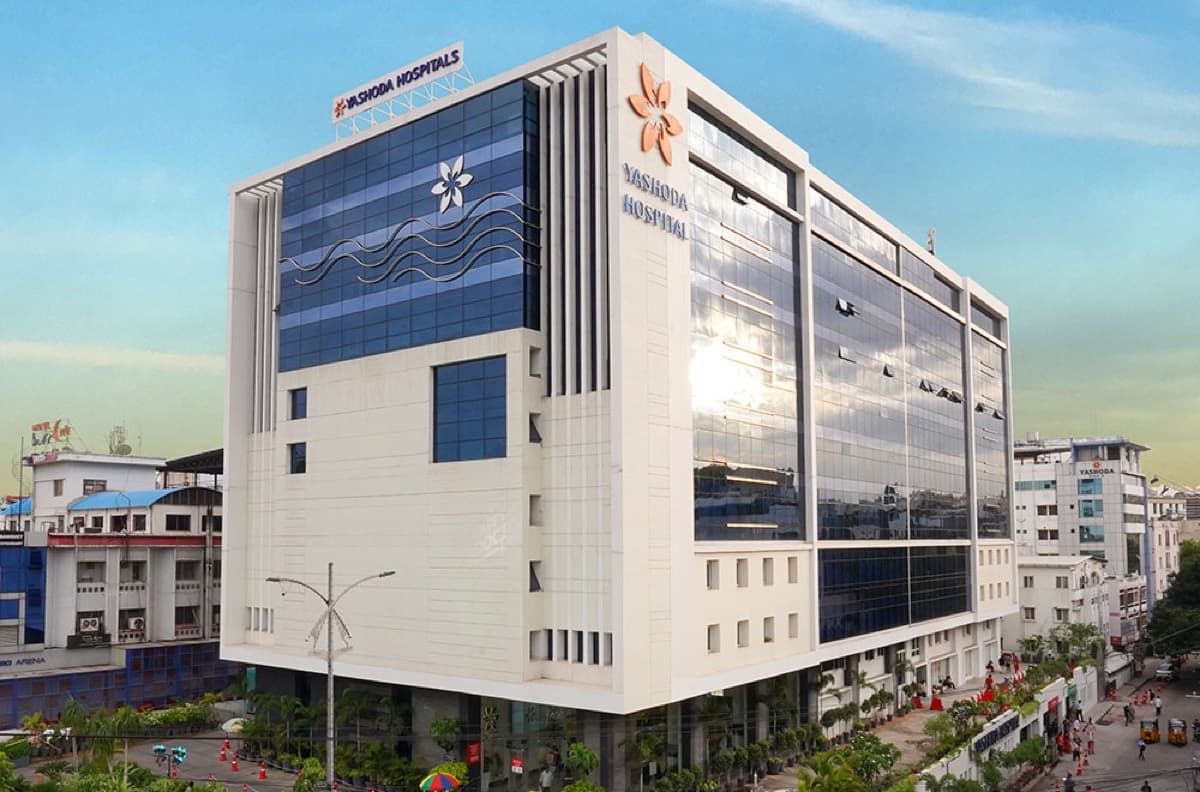The blue glass and white stone frontage of Yashoda Hospitals at Somajiguda, Hyderabad.